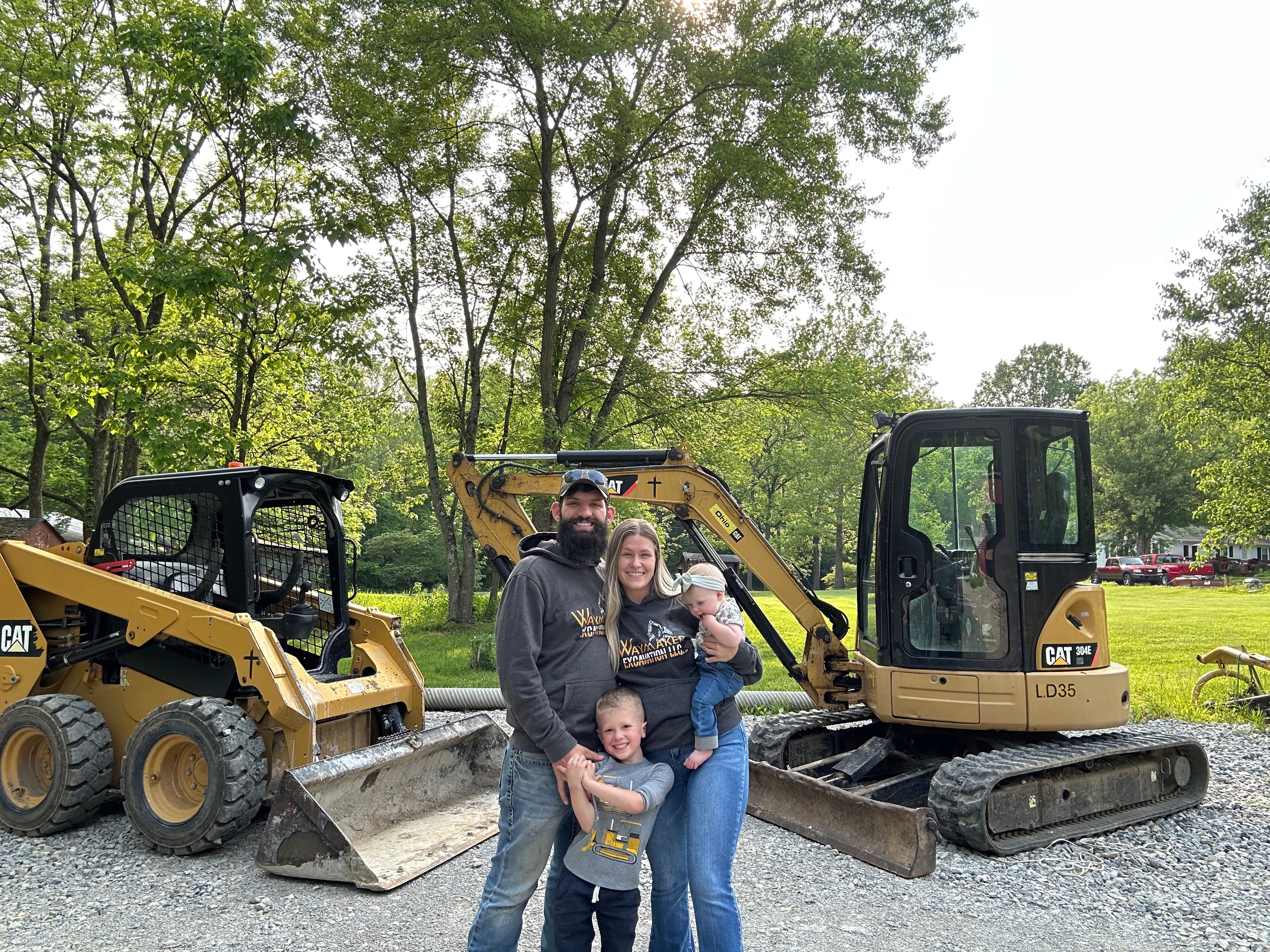 Max Langdon and family with Waymaker Excavation CAT equipment